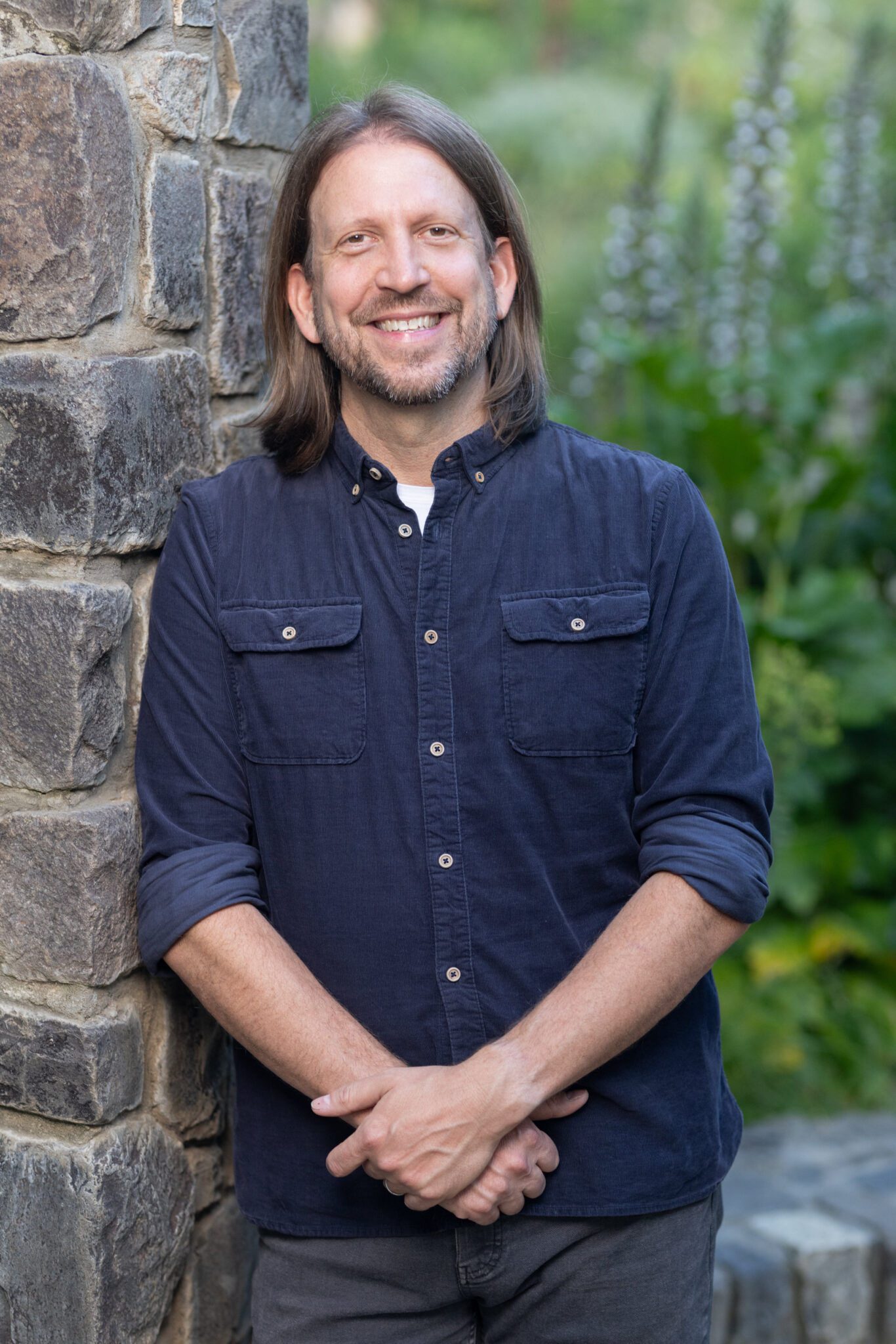 ian headshot button up standing smile no edit